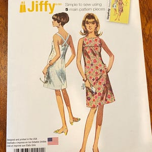 May include: Simplicity Jiffy pattern 1101 for dresses. The pattern features two dress designs, one with a criss-cross back and the other with a floral print. The package includes the text "Simple to sew using 5 main pattern pieces."