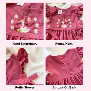 May include: A dusty rose-colored dress with hand embroidery, ruffle sleeves, and a round neck. The dress features a whimsical embroidered goose holding a balloon with the number 1, surrounded by daisy flowers. Buttons are on the back.