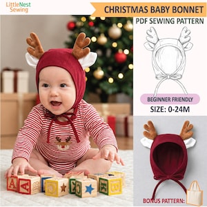 May include: A PDF sewing pattern for a Christmas baby bonnet featuring a deep red fabric with plush brown reindeer antlers and white ear accents. The pattern includes instructions for sizes 0-24M, illustrated with a line drawing and a finished bonnet.