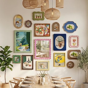 May include: A gallery wall featuring a collection of various framed art prints and a mirror. The frames include scalloped, rectangular, and oval shapes in colors like green, blue, pink, yellow, and wood tones. The art depicts food, landscapes, and still life.