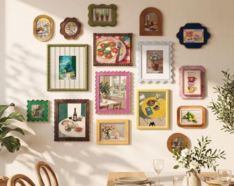 May include: A gallery wall arrangement featuring fifteen assorted picture frames in various shapes, colors, and textures, including scalloped, oval, and rectangular designs. The frames contain diverse illustrations of food, flowers, and landscapes.