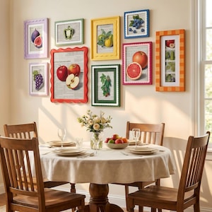 May include: A dining room scene featuring a round table with a beige tablecloth, four wooden chairs, and a vase of flowers. On the wall, eight colorful picture frames display various fruit illustrations, including apples, grapes, and citrus.