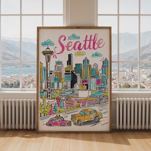 May include: A framed art print featuring a colourful, hand-drawn style illustration of the Seattle skyline. The word Seattle is written in pink script at the top. The image includes the Space Needle, various skyscrapers, and two cars in the foreground.