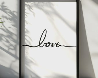 Puede incluir: Una impresión de arte mural rectangular en un marco negro fino que presenta un fondo blanco con la palabra love escrita en una sola línea cursiva negra continua que se extiende horizontalmente por el centro de la composición.