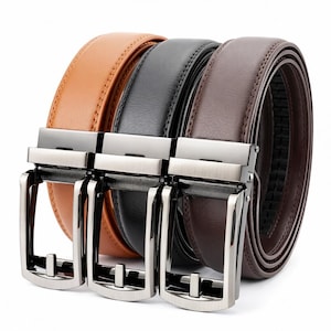 May include: Three leather belts in shades of brown, black, and dark brown, each with a silver-colored buckle. The belts are arranged side by side, showcasing their different colors and textures. The buckles have a modern, minimalist design.