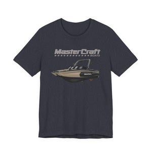 May include: Dark navy blue t-shirt featuring a graphic of a boat with the text "MasterCraft Boats" above it. The boat is tan, black, and white. The text is in a silver color.