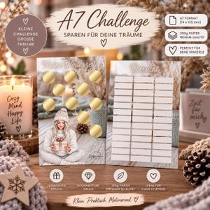 Könnte beinhalten: A7 Spar-Challenge Karten im Format 74 x 105 mm auf 300g Premium-Papier. Eine Karte zeigt goldene Rubbelfelder und ein winterliches Motiv, die andere bietet eine weiße Übersichtstabelle zur Dokumentation der persönlichen Sparziele.