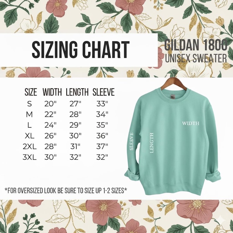 Puede incluir: Una sudadera unisex Gildan 1800 de color verde azulado claro cuelga de una percha de madera. La imagen incluye una tabla de tallas con medidas en cent&iacute;metros para el ancho, el largo y el largo de la manga, que van desde la talla S hasta la 3XL. El texto dice "TABLA DE TALLAS".