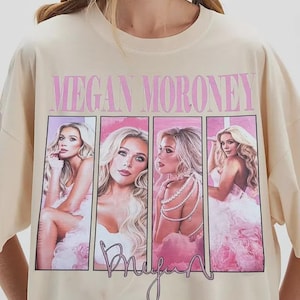 Puede incluir: Camiseta color crema con el nombre "Megan Moroney" en rosa sobre cuatro im&aacute;genes enmarcadas de una mujer en rosa. La palabra "Bruja" est&aacute; escrita en cursiva debajo de las im&aacute;genes.