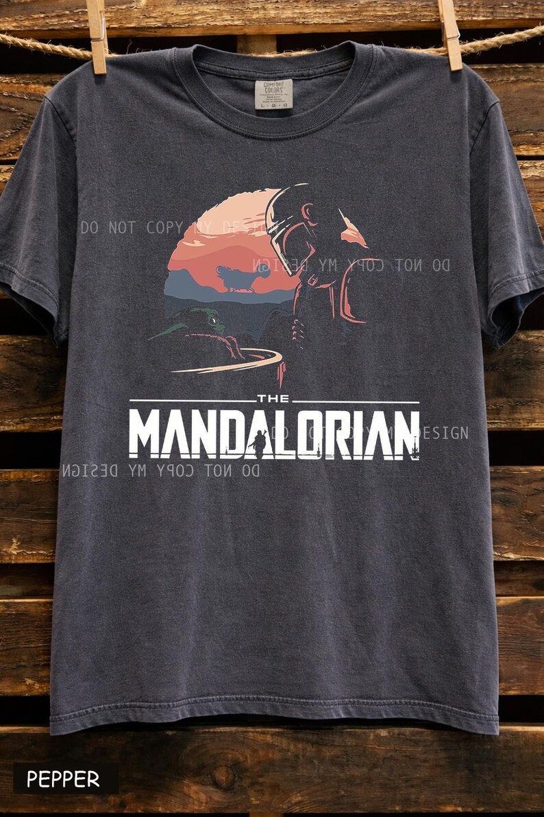Oversized vintage black graphic t shirt featuring The Mandalorian and Grogu inspired sci fi sunset design, unisex Star Wars fan apparel with retro aesthetic print.