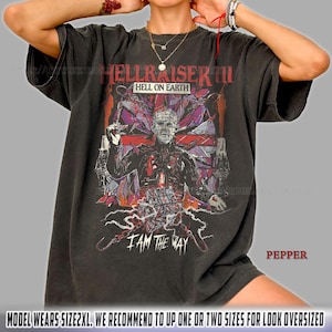 May include: Dark gray t-shirt featuring a graphic from the movie "Hellraiser III: Hell on Earth." The design includes the film's title, a character illustration, and the phrase "I AM THE WAY." The shirt is a relaxed fit.