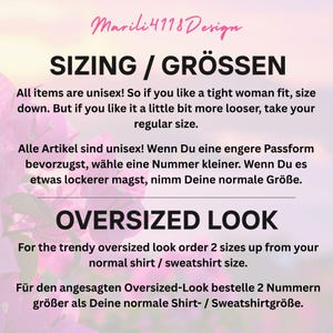 May include: Image with text from Marili4118 Design. The text discusses sizing, stating all items are unisex. It advises sizing down for a tighter fit and ordering two sizes up for an oversized look. The background has pink flowers.