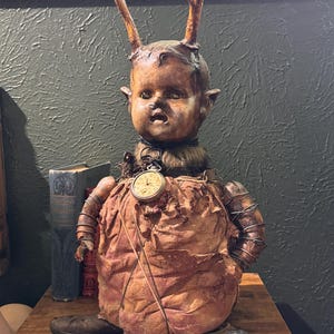 Assemblage art found objects repurposed doll oddities macabre art assemblage