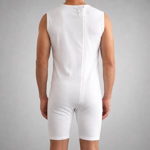 May include: White sleeveless bodysuit with a full-length zipper down the back. The garment is made of a soft, opaque fabric and has a high neckline. The shorts end above the knees.