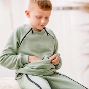 Adaptief kindersweater met dubbele ritssluiting aan de voorkant voor voedingsslang, insulinepomp en toegang