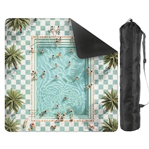 May include: A rectangular beach blanket featuring a pool scene with people swimming and sunbathing. The blanket has a checkered pattern in shades of blue and white, with palm trees around the pool. A black carrying bag is included.