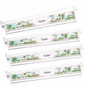 May include: Four clear plastic label holders with a watercolor design of palm trees and a beach scene. Each holder has a pink border and the word "Name" in a cursive font. The label holders are designed for organization.