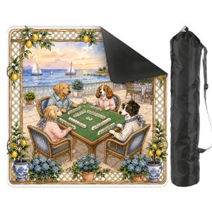 May include: A rectangular mat featuring a watercolor illustration of four dogs playing mahjong on a patio overlooking the ocean. The mat has a black backing and is accompanied by a black carrying bag with a shoulder strap. Lemon trees and blue flower pots frame the scene.