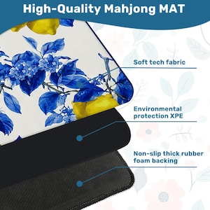 May include: A high-quality Mahjong mat with a floral design featuring blue leaves and yellow lemons. The mat has a soft tech fabric surface, environmental protection XPE, and a non-slip thick rubber foam backing. The text "High-Quality Mahjong MAT" is at the top.