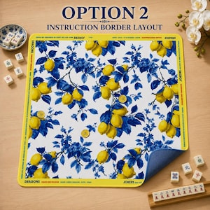May include: A white mat with a blue and yellow lemon and floral design. The mat has a yellow border with text that reads "OPTION 2 INSTRUCTION BORDER LAYOUT". Mahjong tiles and a small dish are visible.