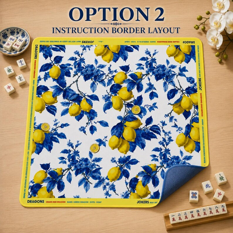 May include: A white mat with a blue and yellow lemon and floral design. The mat has a yellow border with text that reads "OPTION 2 INSTRUCTION BORDER LAYOUT". Mahjong tiles and a small dish are visible.