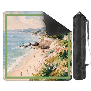 May include: A rectangular yoga mat featuring a coastal landscape painting with a green border. The artwork depicts a beach scene with figures, ocean waves, and cliffs. A black carrying bag is included.