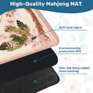 May include: A high-quality Mahjong mat with a floral design in pink, beige, and brown. The mat features a soft tech fabric, environmental protection XPE, and a non-slip thick rubber foam backing. The text "High-Quality Mahjong MAT" is at the top.