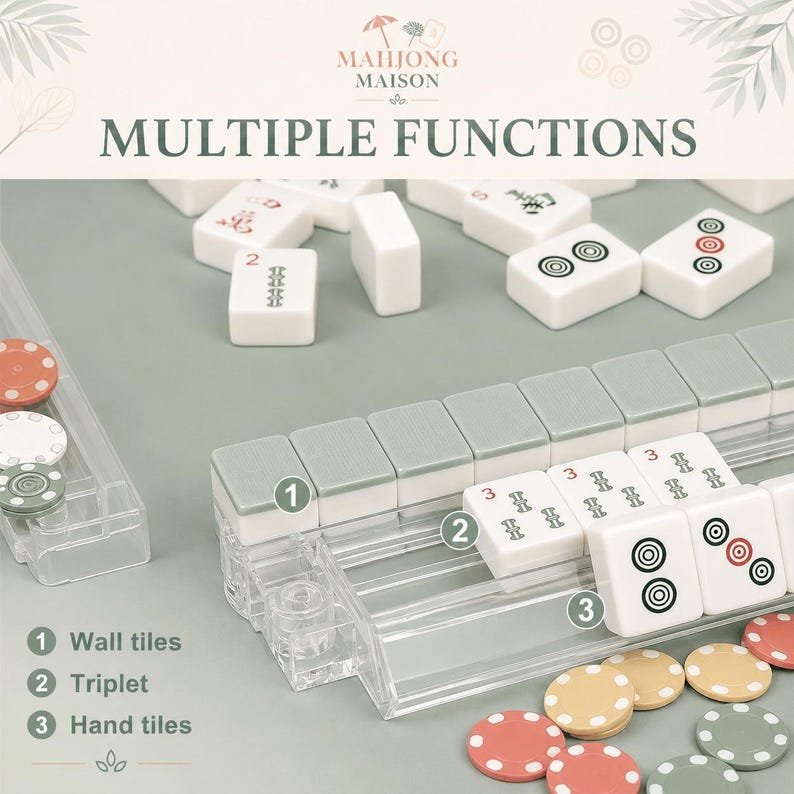 Puede incluir: Un juego de Mahjong Maison con fichas blancas que presentan marcas negras, rojas y verdes, dispuestas sobre soportes de pl&aacute;stico transparente. El set incluye fichas de pared, tripletes y fichas de mano, junto con peque&ntilde;as fichas redondas.