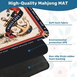 May include: A rectangular mahjong mat featuring a nautical design with a gold anchor, red ribbons, and the text WALLS LEFT and GREEN DRON DOTS SOAP. The mat consists of a soft tech fabric top, an environmental protection XPE layer, and a black rubber backing.