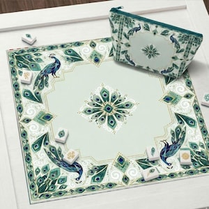 May include: A teal and white Mahjong set featuring a peacock design. The set includes a playing mat, a zippered pouch, and Mahjong tiles. The mat has a peacock feather border and a central peacock feather design. The pouch and mat have a matching design.