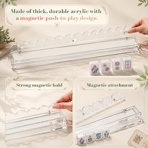 May include: A clear acrylic mahjong tile rack featuring a magnetic push-to-play design with a scalloped top edge. The rack includes a magnetic attachment mechanism for secure tile placement, accompanied by four white mahjong tiles with colorful floral and letter designs.