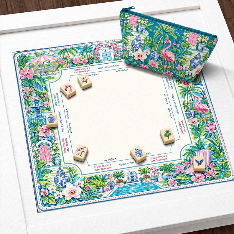 May include: A square Mahjong mat featuring a vibrant tropical garden print with flamingos, palm trees, and blue and white porcelain vases, accompanied by a matching zippered pouch and several ivory-colored tiles with floral and bird illustrations.
