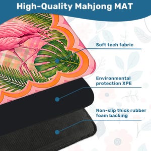 May include: A high-quality Mahjong mat with a flamingo and tropical leaf design. The mat features a soft tech fabric, environmental protection XPE, and a non-slip thick rubber foam backing. The top of the mat is pink, orange, and green.