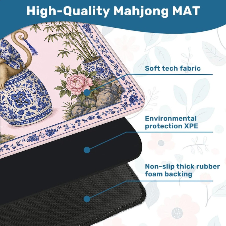 May include: A high-quality Mahjong mat with a floral and monkey design. The mat features a soft tech fabric, environmental protection XPE, and a non-slip thick rubber foam backing. The top layer has a pink background with blue and white floral patterns.