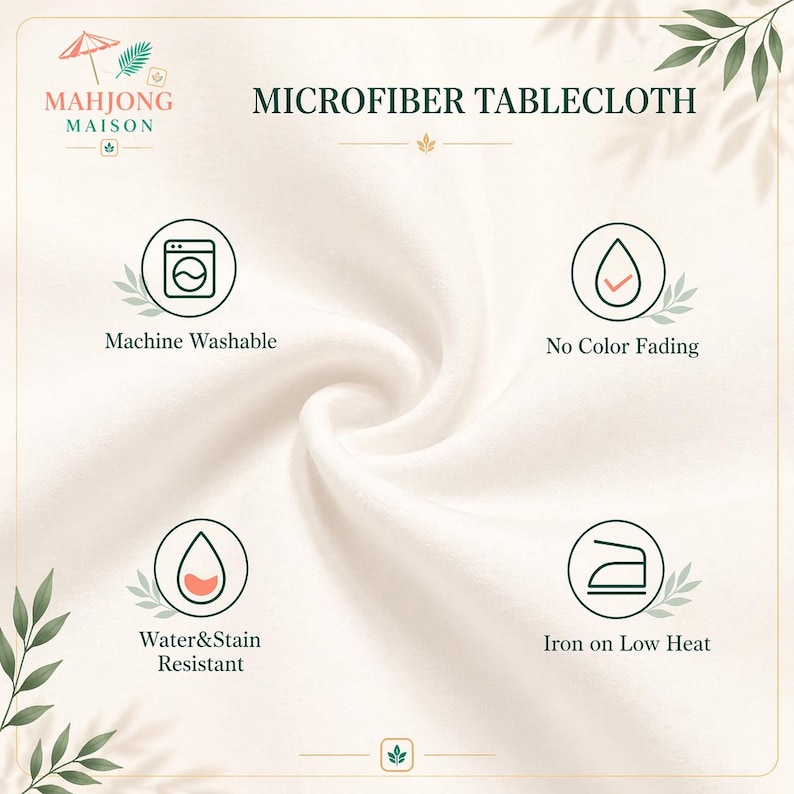 May include: A cream-colored microfiber tablecloth featuring the Mahjong Maison logo and text. Four circular icons display product features: Machine Washable, No Color Fading, Water & Stain Resistant, and Iron on Low Heat, all set against a soft fabric texture.
