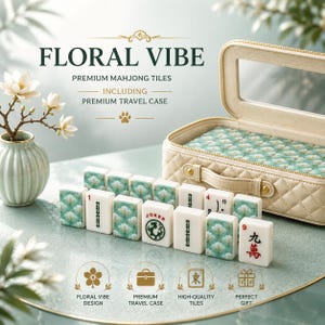 May include: A set of premium mahjong tiles with a floral design, including a travel case. The tiles are white with green floral patterns and black symbols. The case is beige with a quilted pattern and a clear window. The text "FLORAL VIBE" is at the top.
