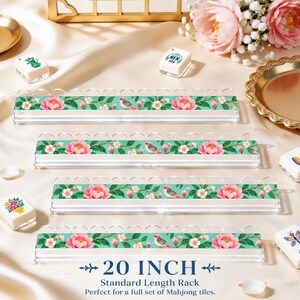 May include: Four clear acrylic mahjong tile racks featuring a teal background with a floral pattern of pink peonies, white blossoms, and small birds. The racks have a scalloped top edge and are labeled as 20 inch standard length racks.