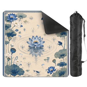 May include: A square mat featuring a blue and cream lotus flower and koi fish pattern with a geometric border, shown with one corner folded to reveal a black underside, accompanied by a black cylindrical carrying bag with a shoulder strap.