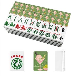 May include: A complete Mahjong set with white tiles featuring green and red symbols, numbers, and characters. The set includes tiles with cocktail and joker designs. The tiles are stacked, with a few individual tiles displayed.