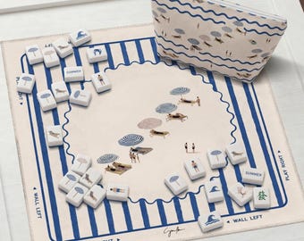 May include: A beach-themed game set with a matching zippered pouch. The game board features a beach scene with umbrellas and people. The game pieces have beach-related icons. The pouch and board have blue and white stripes.