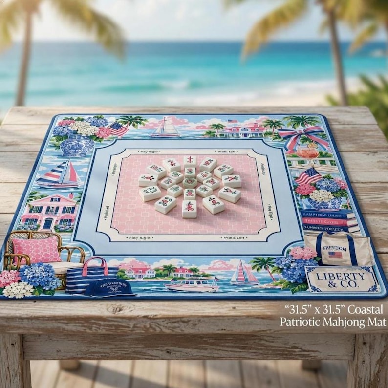 May include: A coastal patriotic mahjong mat, 31.5 x 31.5 inches, with a light blue border and a pink center. The mat features illustrations of sailboats, houses, and floral arrangements. The text "LIBERTY & CO." is visible.