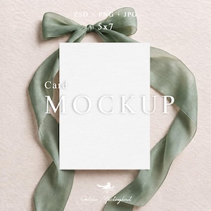 May include: A blank white rectangular card mockup with a 5x7 inch dimension, centered behind a sage green sheer ribbon tied in a bow at the top. The text PSD + PNG + JPG, Card MOCKUP, and Golden Mockingbird are visible on the image surface.