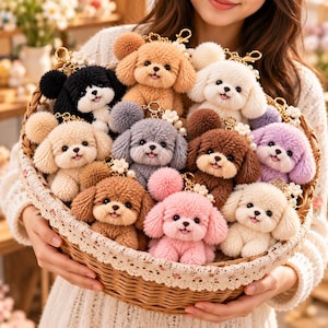 May include: A collection of plush puppy keychains in various colours including black, white, brown, grey, pink, and purple. Each small stuffed dog features a fuzzy texture, a smiling expression, and a gold-toned metal clasp with a small white flower.