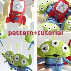 May include: A handmade felt mobile featuring green aliens with three eyes, blue outfits, and red rocket ships. The mobile includes star-shaped accents and the text "pattern+tutorial".