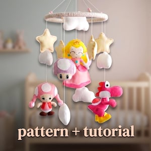 May include: A handmade baby mobile featuring plush characters from the Super Mario Bros. series. The mobile includes Princess Peach, Yoshi, a Toad, stars, and clouds, all suspended from a circular frame. The text "pattern + tutorial" is visible.
