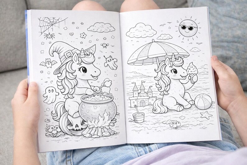 May include: A coloring book open to two pages with unicorn illustrations. One page shows a unicorn in a witch hat stirring a cauldron. The other page shows a unicorn at the beach with an ice cream cone. The book is held open by a person.