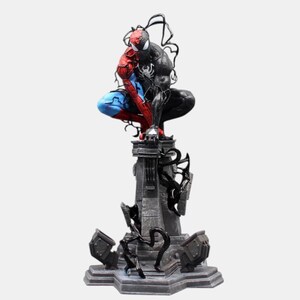 May include: A detailed statue of Spider-Man and Venom in a dynamic pose. The figure is split down the middle, with Spider-Man in red and blue on one side and Venom in black on the other. The statue is mounted on a gray, detailed base.