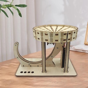 May include: A wooden, DIY marble run kit. The kit features a circular top with rectangular cutouts, supported by curved and straight wooden supports. The base is rectangular with four circular cutouts.