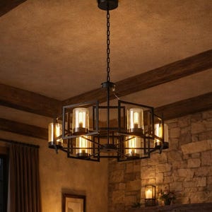 May include: A warm and inviting living room scene. A black geometric chandelier hangs from the ceiling, providing illumination. Brown leather sofas and a stone fireplace contribute to the rustic feel. Candles and a lit fire create a cosy atmosphere.