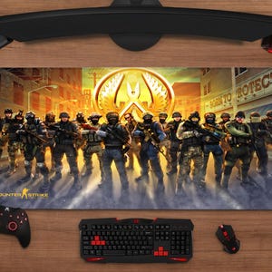 May include: A white ceramic mug with a black handle and the text "But First, Coffee" in a handwritten style. The mug is on a white surface. The mug is approximately 10 cm tall.